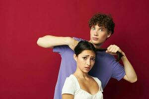 a guy and a girl next to him holding a pigtail emotions photo