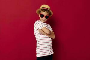 boy wearing sunglasses wearing a hat posing childish style photo