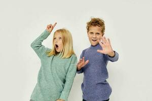 Boy and girl in multi-colored sweaters posing for fun Lifestyle unaltered photo