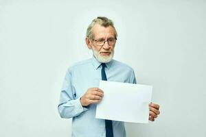 Portrait of happy senior man work office blank sheet of paper light background photo