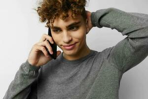 Attractive man talking on the phone posing emotions isolated background photo