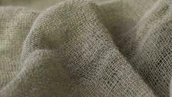 Gray natural burlap fabric. Closeup video