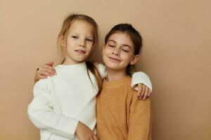 two cute little girls hug friendship childhood posing photo