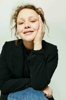 cheerful woman sitting on a chair in a black jacket fashion posing Lifestyle unaltered photo