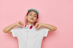 little girl headphones in a white t-shirt and a cap childhood unaltered photo