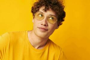 guy with red curly hair wearing stylish glasses yellow t-shirt posing Lifestyle unaltered photo