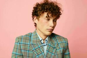 Young curly-haired man gesturing with his hands emotions checkered jacket Lifestyle unaltered photo