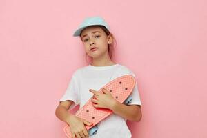 little girl cap in white t-shirt skateboard childhood unaltered photo