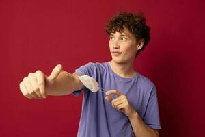 young guy in purple t-shirts medical mask in hands safety Lifestyle unaltered photo