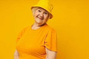 smiling elderly woman happy lifestyle in a yellow headdress close-up emotions photo