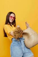 young beautiful woman straw bag emotions summer style yellow background photo