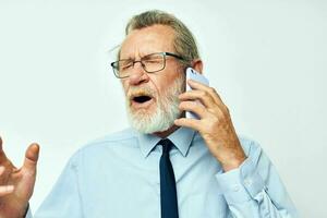 old man in a shirt with a tie talking on the phone cropped view photo