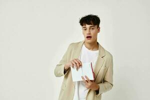 portrait of a young man posing with a notepad in a suit isolated background unaltered photo