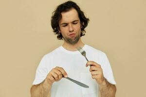 Attractive man cutlery in hand posing Lifestyle unaltered photo