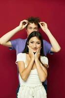 a young couple summer style posing fashion emotions red background photo