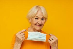 elderly woman in casual t-shirt medical mask isolated background photo