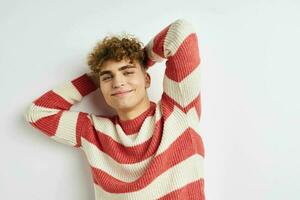 kinky guy in a striped sweater posing light background photo