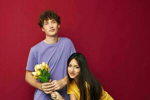 portrait of a man and a woman a bouquet of yellow flowers based friendship yellow background unaltered photo