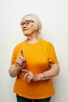 Photo of retired old lady in casual t-shirt and glasses close-up