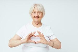 elderly woman in a white t-shirt light background photo