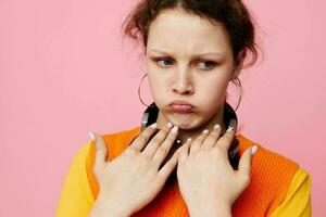 portrait of a young woman in an orange sweater headphones music entertainment cropped view unaltered photo