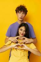 cute young couple Friendship posing fun studio yellow background unaltered photo