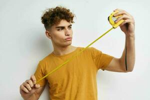 handsome guy grimace measuring tape posing Lifestyle unaltered photo