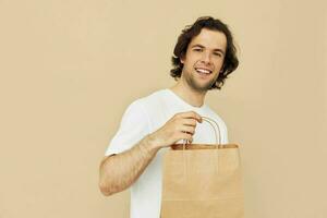 handsome man paper grocery bag posing isolated background photo