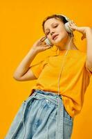 cheerful woman grimace headphones music technology yellow background unaltered photo
