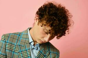portrait of a young curly man gesturing with his hands emotions checkered jacket Lifestyle unaltered photo