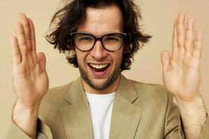 handsome man with glasses emotions gesture hands posing beige background photo