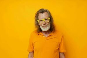 Portrait of happy senior man in yellow glasses with a gray beard emotions cropped view photo