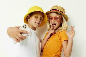 children in hats with phone together friendship photo