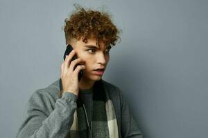 Attractive man in a plaid scarf looking at the phone fashion Lifestyle unaltered photo