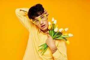 Photo of romantic young boyfriend give flowers wear spectacles yellow shirt Lifestyle unaltered