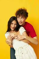 teenagers hug together antics yellow background unaltered photo