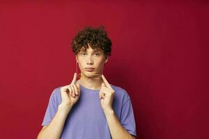 Young curly-haired man posing emotions close-up isolated background photo