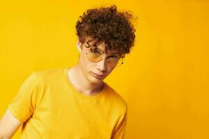 guy with red curly hair Youth style glasses studio casual wear yellow background unaltered photo