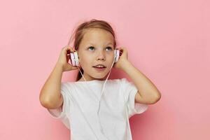 Portrait of happy smiling child girl smile posing headphones isolated background photo