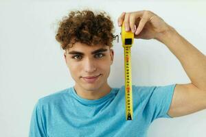 Attractive man yardstick in hand in blue t-shirts Lifestyle unaltered photo