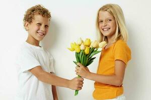 Boy and girl fun birthday gift surprise bouquet of flowers isolated background unaltered photo