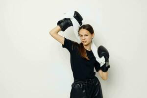 athletic woman in boxing gloves in black pants and a T-shirt isolated background photo
