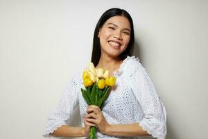 Charming young Asian woman with a bouquet of flowers smile close-up Lifestyle unaltered photo