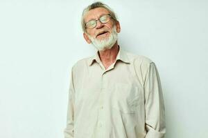 Portrait of happy senior man with a gray beard in a shirt and glasses cropped view photo