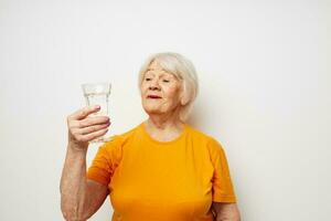 Photo of retired old lady holding a glass of water health close-up emotions