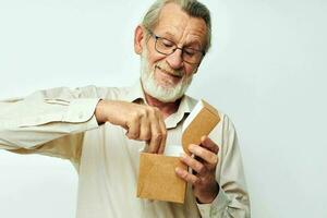 Old man with a box in his hands in studio alone photo