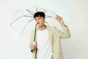 handsome guy transparent umbrella a man in a light jacket isolated background unaltered photo