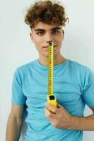 Attractive man yardstick in hand in blue t-shirts Lifestyle unaltered photo