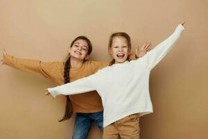 two cute little girls hug friendship childhood posing photo