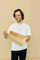 Cheerful man in a white T-shirt with paper bag Lifestyle unaltered photo